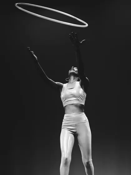 A dramatic shot from my first stage performance, tossing the hoop in the air. That moment of release and catch is always a thrill. This performance was a huge step for me in my hoop journey.