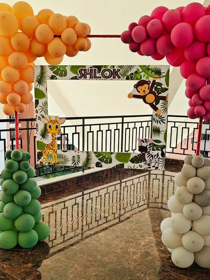 Another angle of the jungle-themed photo booth frame for Shlok's party. The balloon columns on either side add a festive and colorful touch.