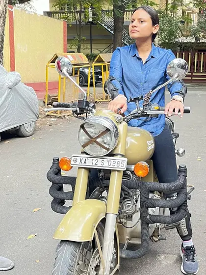 A graduate sits confidently on her bike, ready for her next ride. She has the skills and the attitude to conquer any road.