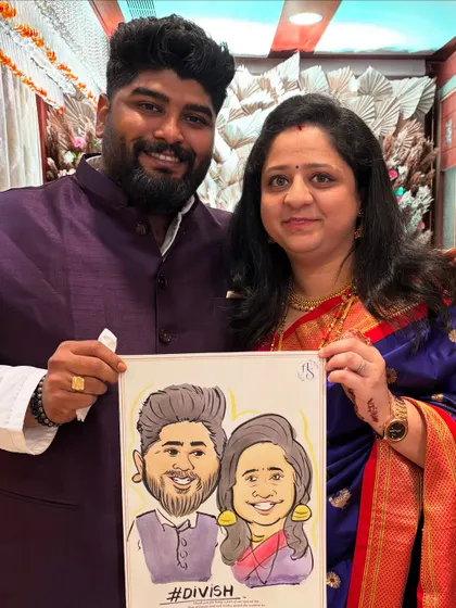 A happy couple posing with their personalized caricature, complete with their couple hashtag. It's a wonderful way to capture the spirit of their relationship.