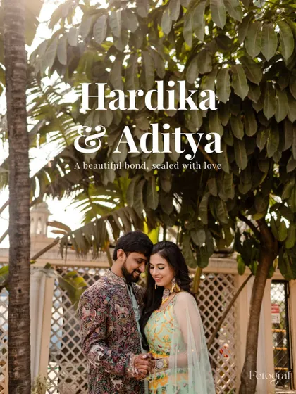 A beautiful portrait of the couple at their Sangeet, surrounded by lush floral decorations.
