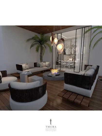 A duplicate of the outdoor lounge with the fire pit, this view offers a clearer look at the comfortable, modern furniture and the tropical ambiance created by the palm trees.