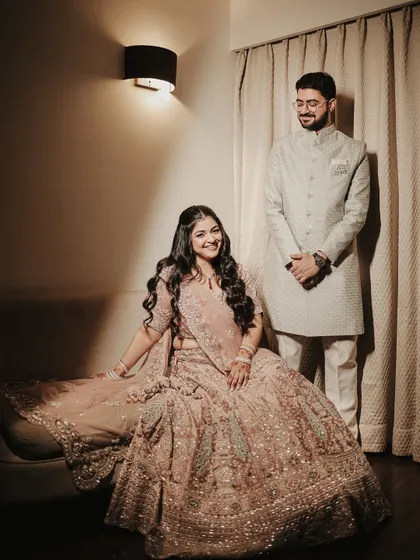 An elegant and formal portrait of the couple for their Roka ceremony. Her intricate lehenga and his classic sherwani are beautifully captured in this poised and graceful shot.