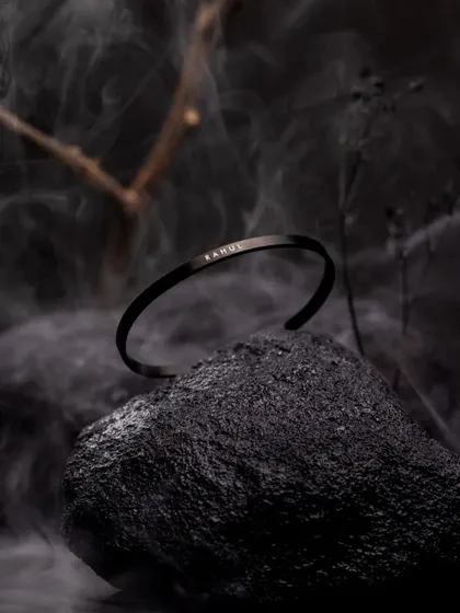 Accessory photography is about creating a mood. Here, I used dramatic, low-key lighting with smoke and natural elements to give this minimalist bracelet a bold, masculine, and luxurious feel for a creative product campaign.