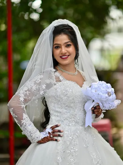 For my Christian brides, I aim for an aura of soft, ethereal glam. This look features a flawless HD makeup base that lasts through vows and celebrations, a defined eye, and a bold lip that complements the pristine white gown, ensuring she feels timeless and graceful.