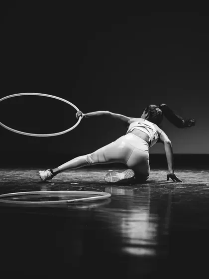 Captured in motion during my debut hoop performance. This move shows the dynamic and athletic side of hoop dance, combining floorwork with the flow of the hoop.