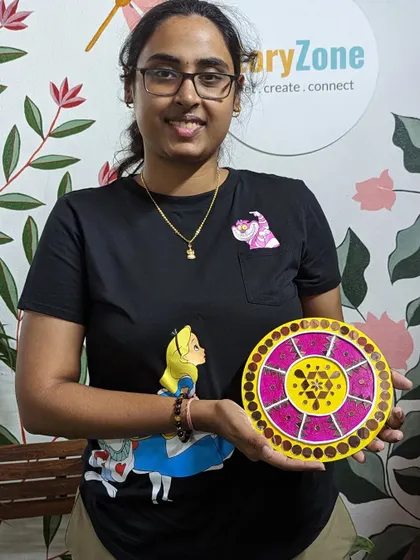 A participant with her beautiful Lippan art piece, created during our Onam-themed workshop.