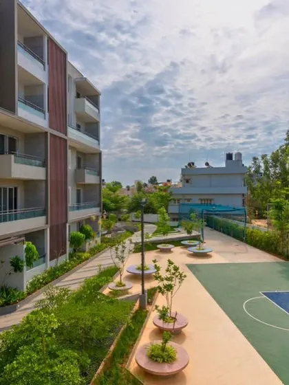 This view of POETREE shows how recreational amenities like a basketball court are woven into the landscape. The space is designed for active use while being surrounded by calming greenery and thoughtful seating areas.