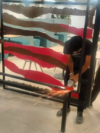 The making of the tapestry installation, with sparks flying as the metal frame is constructed.