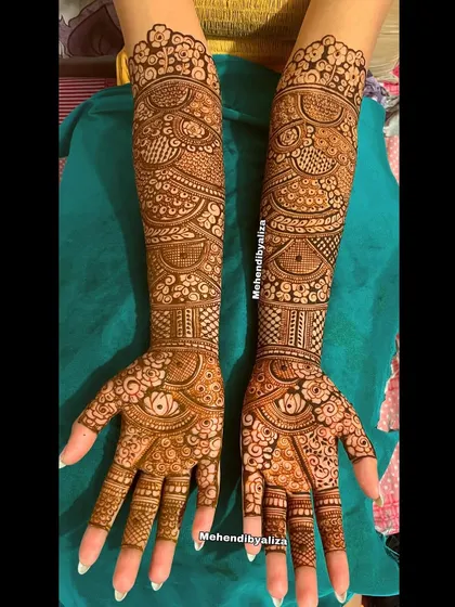 The completed masterpiece for a lovely bride. This design is packed with details, from tiny flowers to bold, filled-in sections, creating a stunning contrast.