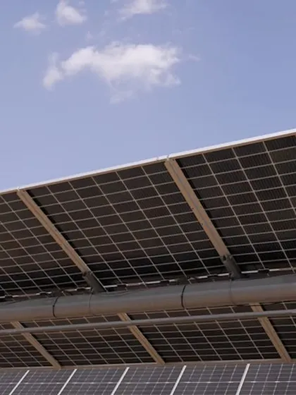 A detailed view of the single-axis trackers used in our solar farms. These trackers follow the sun's path throughout the day, significantly increasing energy generation compared to fixed-tilt systems and maximizing our clients' return on investment.