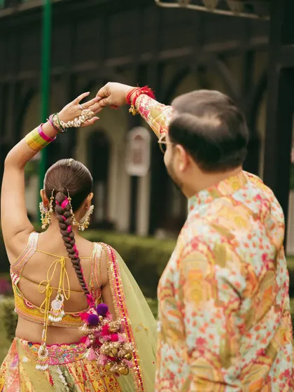 A beautiful shot from the back, showing off the intricate parandi braid and the colorful details of her lehenga.
