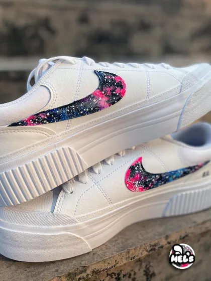 A stacked view of the galaxy swoosh sneakers, showing the vibrant pink and blue cosmic pattern.