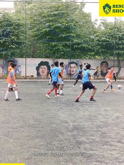 A wide view of a practice match in progress, with our players spread across the turf, learning to maintain their positions and anticipate the play.