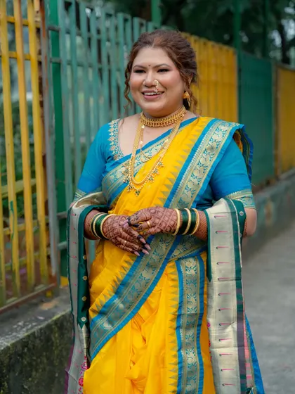 A full-length view of the bride's Nauvari look. This shot shows the beautiful color combination of the saree and the graceful way it's draped.