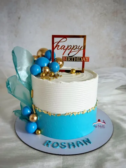 A classy blue and gold cake, perfect for a man's birthday. The design is simple, modern, and elegant.