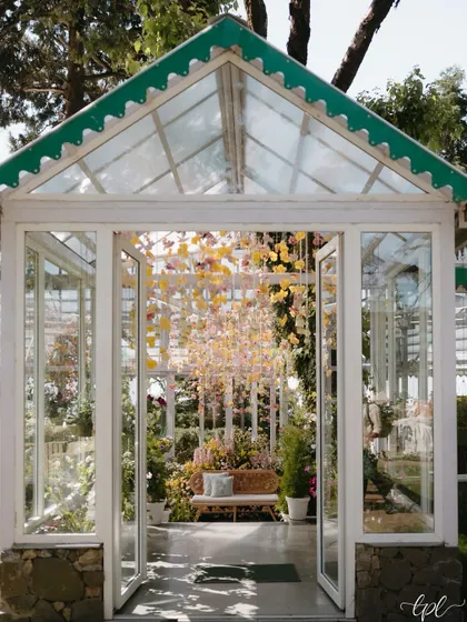 The entrance to the glasshouse, offering a glimpse of the magical Haldi setup inside. The structure of the venue itself became a key part of the overall design.