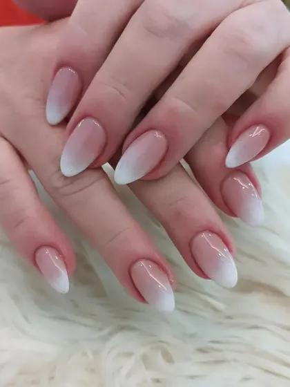 A perfectly executed set of classic almond-shaped ombre nails, showing the clean lines and glossy finish we are known for.