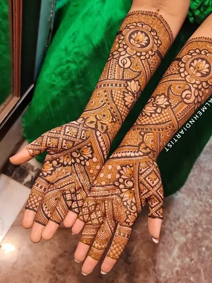 This non-figurative bridal henna is a masterpiece of patterns. The design flows from the wrist to the fingertips, featuring lotus mandalas and intricate grid work for a truly stunning effect.