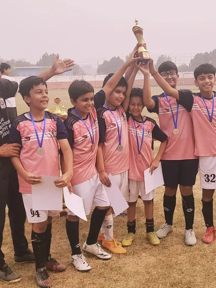 Another angle of our victorious Under-11 team, with a coach sharing in the celebration. We win and lose as a team.