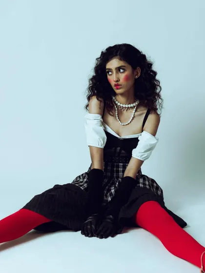 A portrait capturing a moment of feigned surprise, adding to the theatricality of the vintage-modern concept.