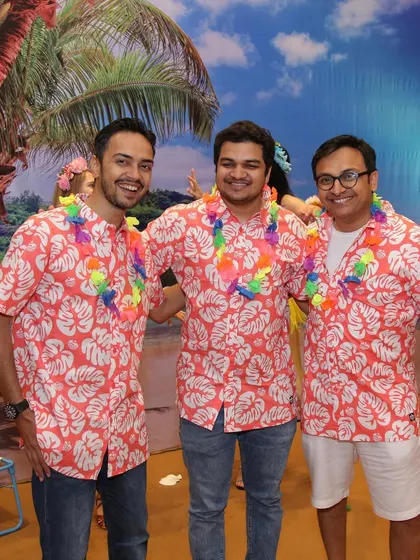 Guests embracing the Hawaiian theme with matching shirts. It's all about creating a fun, immersive experience where everyone feels part of the celebration.