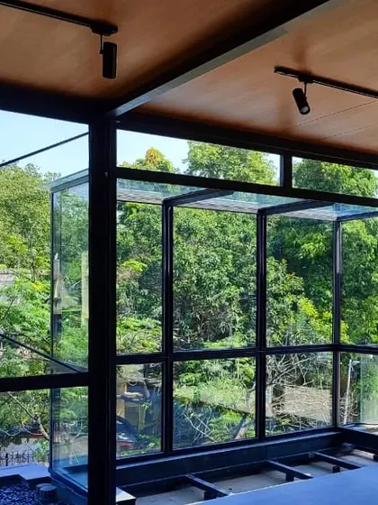 This lightweight, insulated glass cube in Golflinks, New Delhi, acts as a structural and experiential link between the home's interior and the lush greenery outside, dissolving the boundary between inside and out.