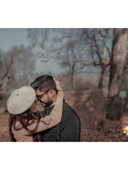 An intimate embrace amidst the beautiful autumn trees of Kashmir. The warm tones and soft light create a cozy and romantic atmosphere.