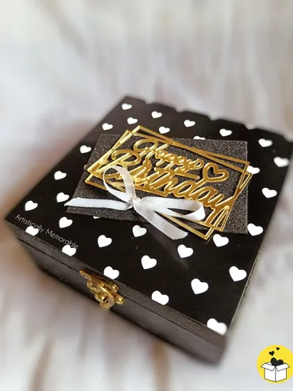 A detailed shot of the mini box hamper, showing the golden clasp and the pretty white bow on the birthday tag.