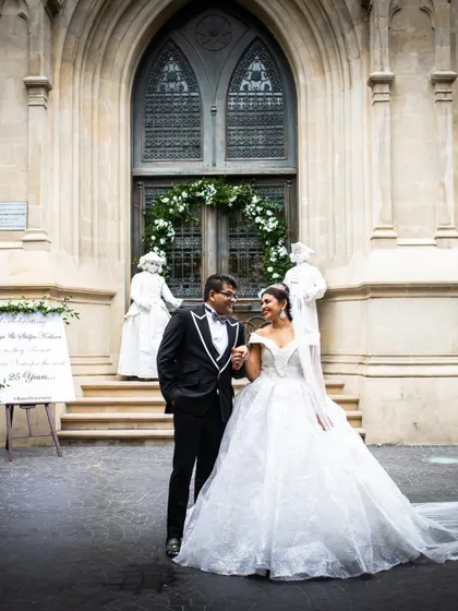 A timeless portrait of a couple after their church ceremony, with the bride in a stunning white ballgown.