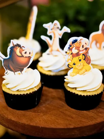 Vanilla cupcakes topped with buttercream and detailed cutouts of Simba, Timon, and Pumbaa were a delightful addition to the dessert spread.