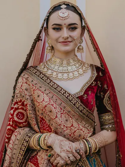 A classic, smiling portrait of the bride looking directly at the camera. Her happiness and confidence shine through in this beautiful, traditional shot.