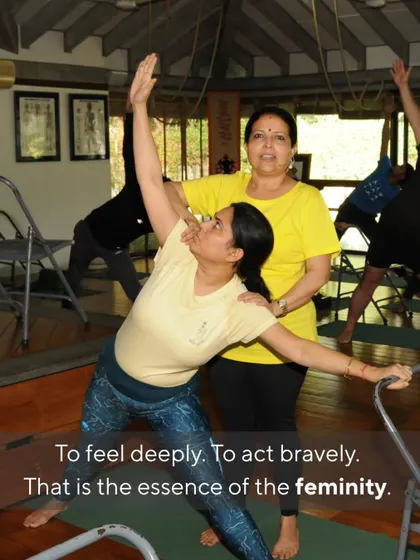 To feel deeply and to act bravely. That is the essence of femininity. Here, I guide a student in a supported Trikonasana (Triangle Pose), helping her find both strength and openness.