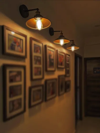 A close-up of the gallery wall, showing how focused lighting can turn a simple hallway into a meaningful display of memories.