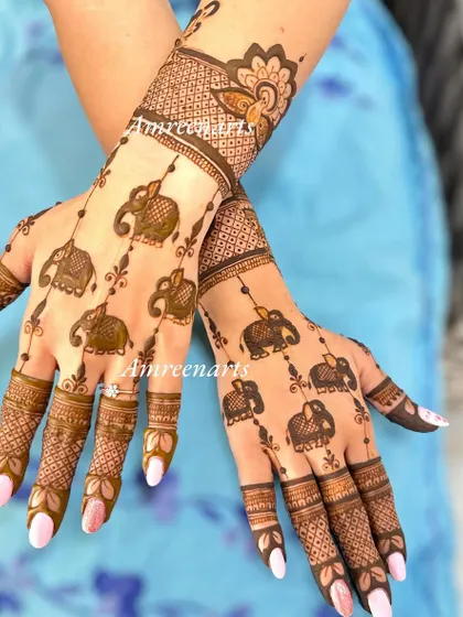 A playful and modern design featuring dangling elephant charms. This pattern is light and airy, perfect for someone who wants a unique and minimalist mehandi.