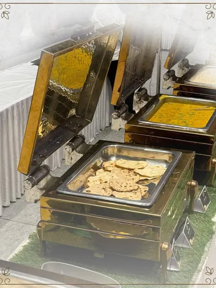 A classic buffet setup with fresh rotis and dal makhani served in beautiful brass chafing dishes. This is a staple of my Punjabi catering, loved for its authentic and comforting flavors.