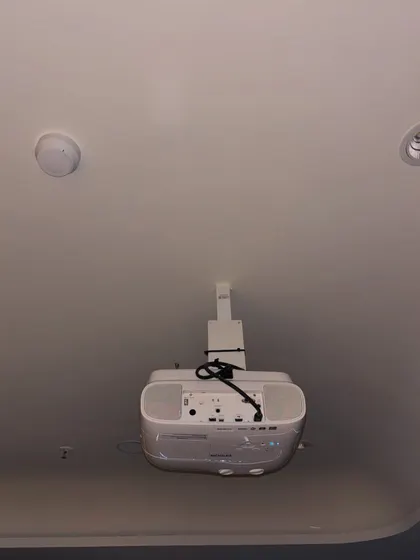 A view of the ceiling-mounted projector, showing the clean wiring and secure bracket. We handle all aspects of the installation to ensure a safe and professional finish.