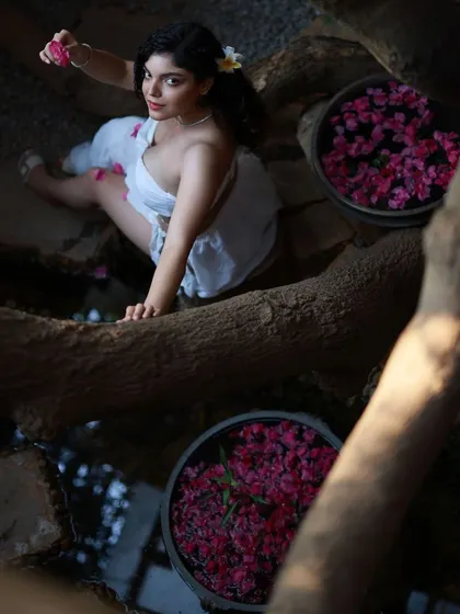 This creative composition uses the environment to frame the model in a unique way. The high-angle perspective and the reflection in the water create a complex and visually interesting image.
