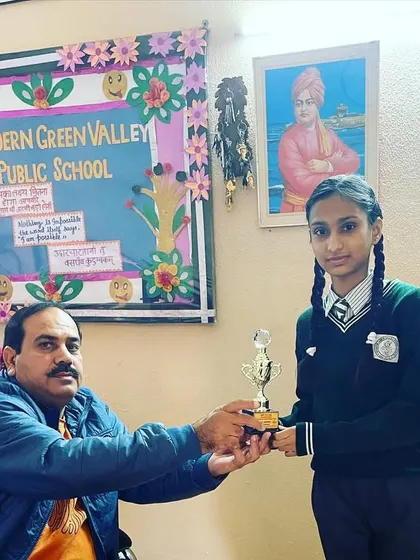 Presenting a trophy to a student at Modern Green Valley Public School for her achievement in an inter-school taekwondo championship.