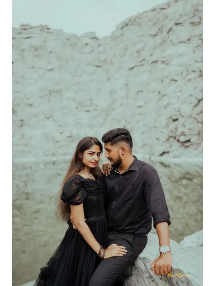 A close-up portrait of a couple by the quarry lake, dressed in black. The focus is on their loving gaze and connection.