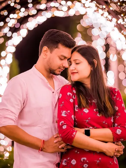 A romantic embrace within a tunnel of lights. The soft, ambient lighting creates a dreamy and intimate atmosphere for this couple's pre-wedding shoot.