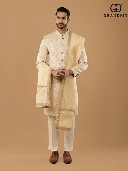 A complete, immaculately curated wedding look. We design every element of the groom's attire, including complementary stoles and accessories, to create a cohesive and distinguished presence.