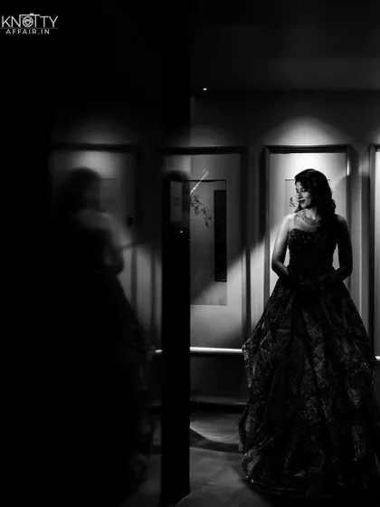 A solitary, moody black and white portrait of the bride, using shadows to create a powerful and introspective image.