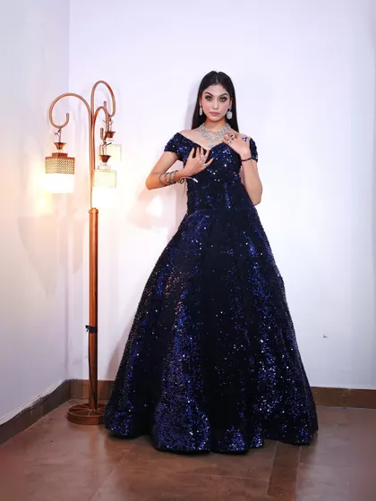 A full-length view of the sparkling midnight blue sequin gown, designed to catch the light from every angle.