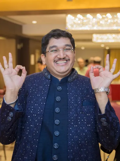 The groom is all smiles and fun, enjoying the Sangeet performances with his family and friends.