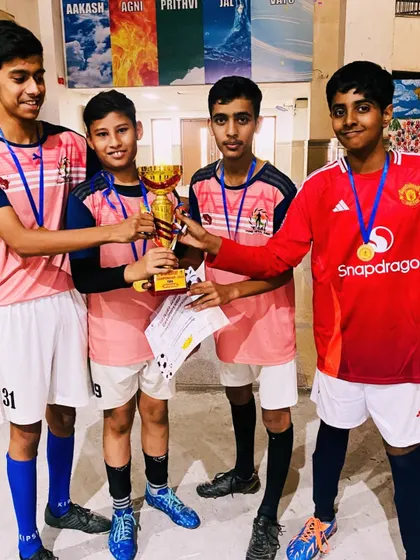 Four of our Under-15 champions holding their trophy. This picture represents the strong bonds of friendship and teamwork forged on the field.