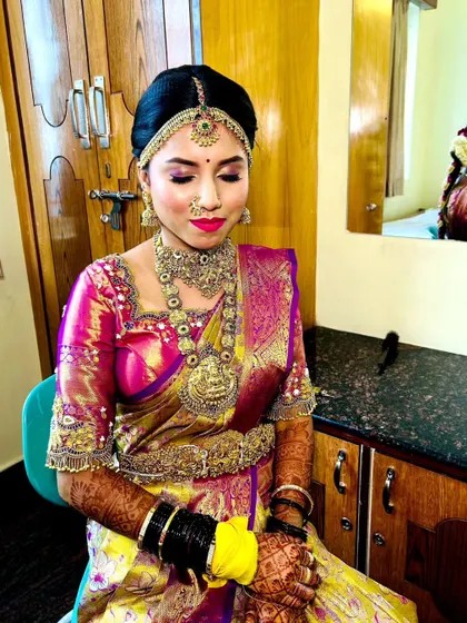 A seated pose that gives a clear view of the intricate henna design and how it pairs with our rental bangles and rings.