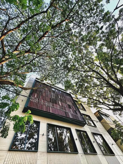 A wider perspective of the mixed-use building, showing how its contemporary design is integrated with the surrounding natural environment.