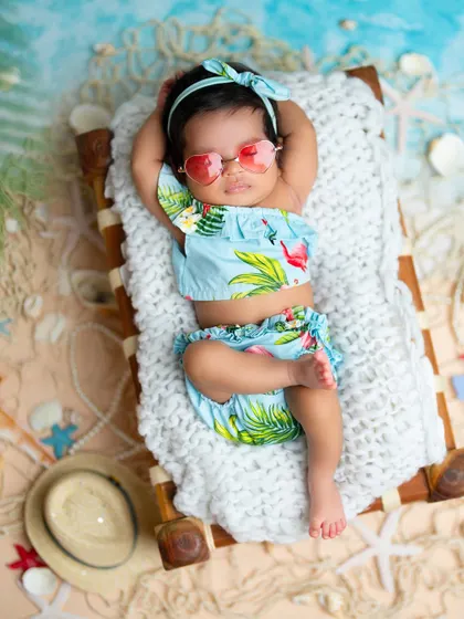 Soaking up the sun in this tropical beach setup. I use real sand, seashells, and miniature beach furniture to create a vacation vibe right in the studio for your little beach baby.
