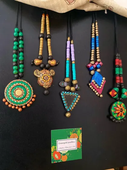 A beautiful array of my terracotta creations. These pieces, with their vibrant colors and diverse designs, are perfect for adding a touch of handmade charm to any outfit.